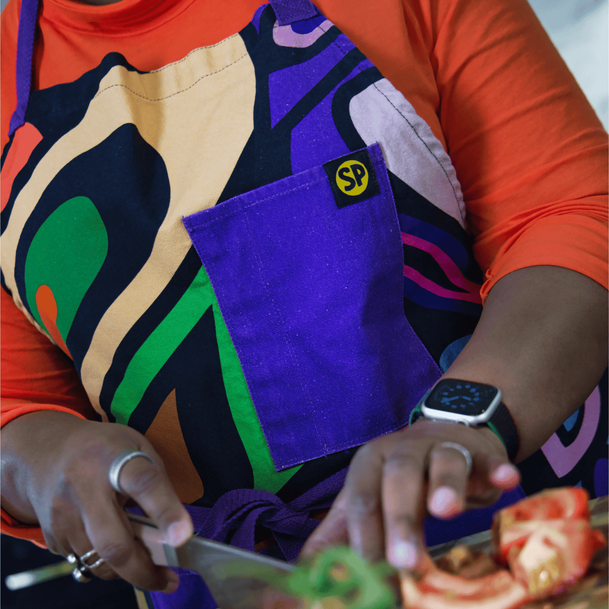 Close-up of the Aravella apron's purple chest pocket