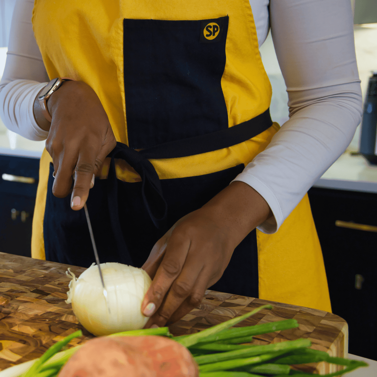 Cornbread Gold apron worn while chopping vegetables