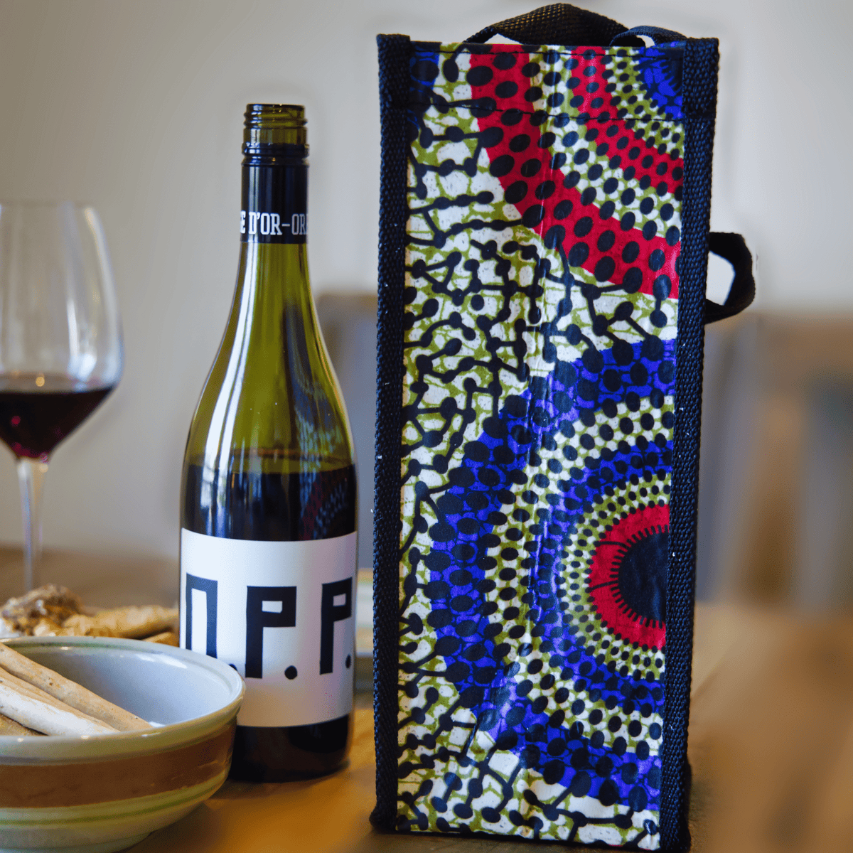 multicolor wine bag with red, blue, yellow, and green circular patterns