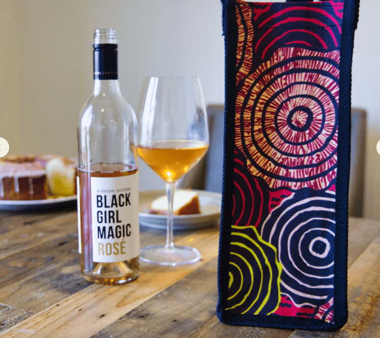 reusable pink circular-pattern wine bag styled at a table