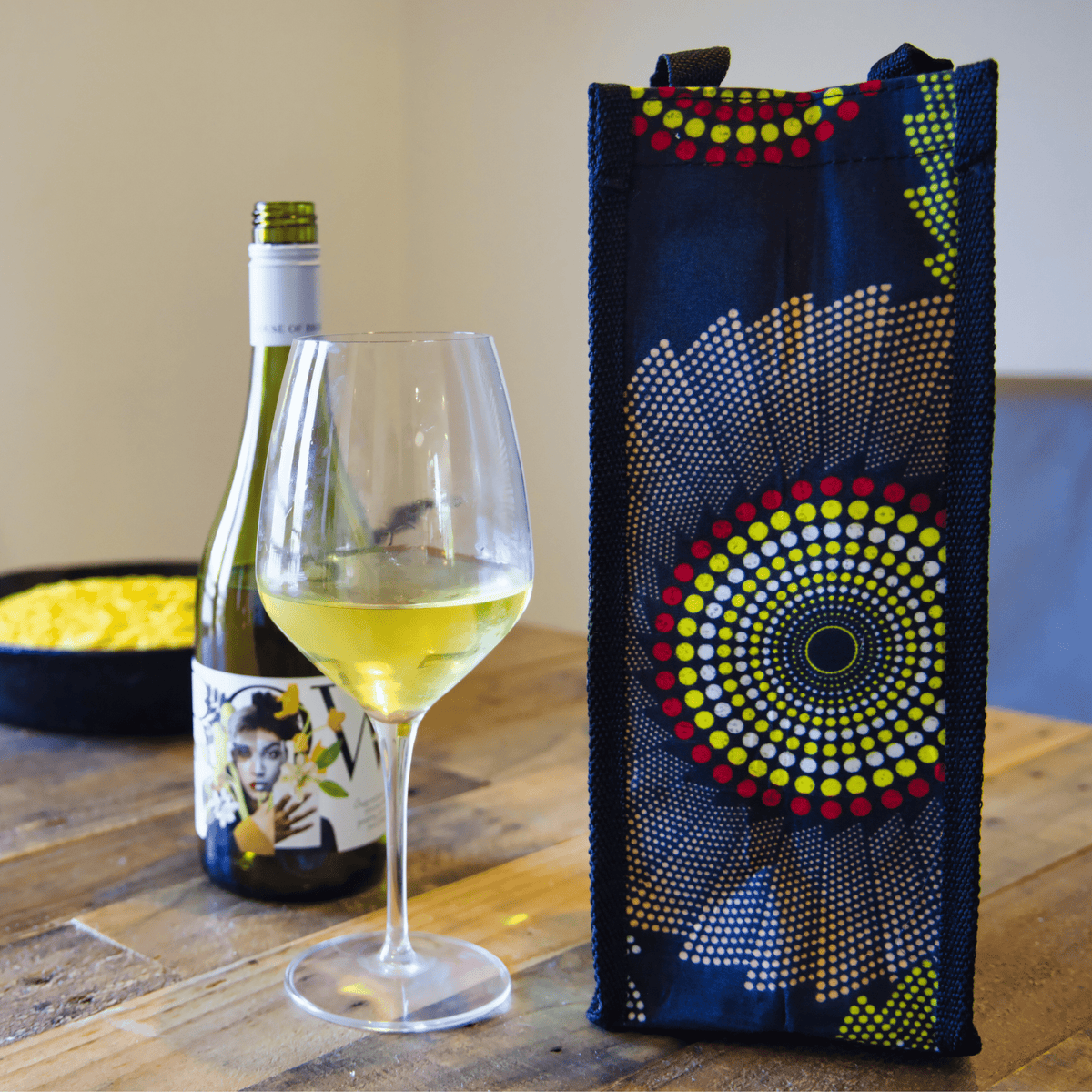 dark wine bag with a large circular yellow-and-blue design